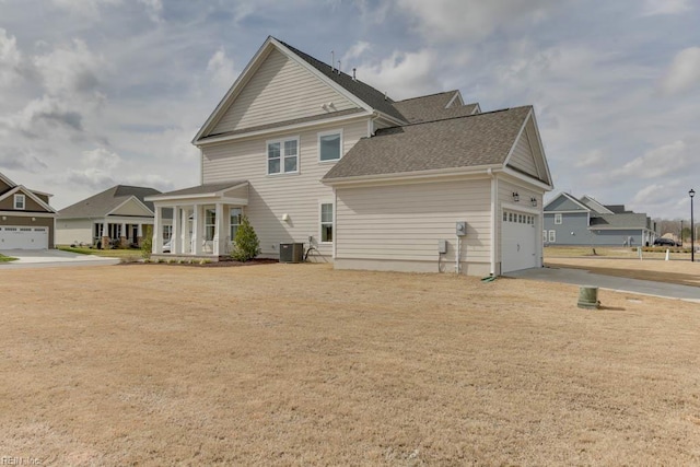 2234 Captiva Ln, Chesapeake, VA 23321 - rear view of house featuring central AC, an attached garage, driveway, and roof with shingles