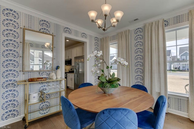 2234 Captiva Ln, Chesapeake, VA 23321 - dining space with wallpapered walls, a chandelier, ornamental molding, wood finished floors, and baseboards