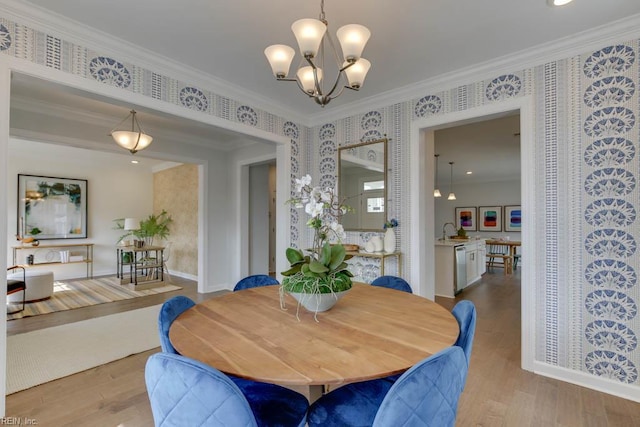 2234 Captiva Ln, Chesapeake, VA 23321 - dining room featuring wallpapered walls, a chandelier, wood finished floors, ornamental molding, and baseboards