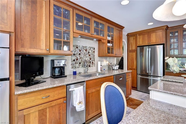 108 Devonshire Dr, Williamsburg, VA 23188 - kitchen with appliances with stainless steel finishes, a sink, light stone countertops, decorative backsplash, and brown cabinetry