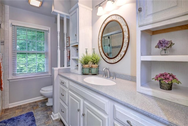 108 Devonshire Dr, Williamsburg, VA 23188 - full bathroom with toilet, a shower, vanity, stone finish floors, and baseboards