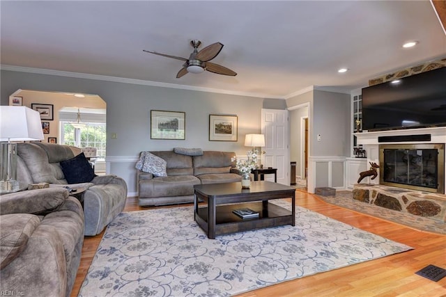 108 Devonshire Dr, Williamsburg, VA 23188 - living area with a ceiling fan, crown molding, wood finished floors, a glass covered fireplace, and arched walkways