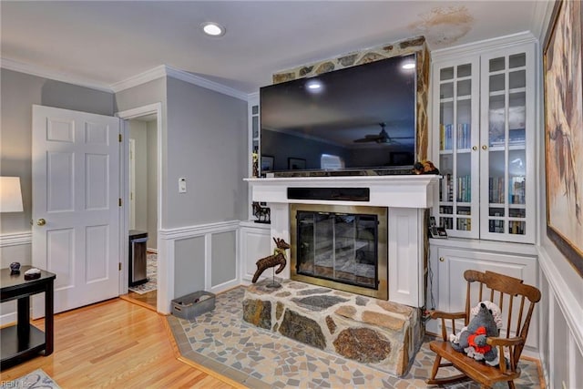 108 Devonshire Dr, Williamsburg, VA 23188 - living area featuring a glass covered fireplace, light wood-type flooring, crown molding, recessed lighting, and wainscoting