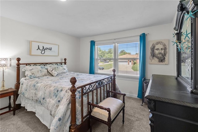 carpeted bedroom featuring baseboards