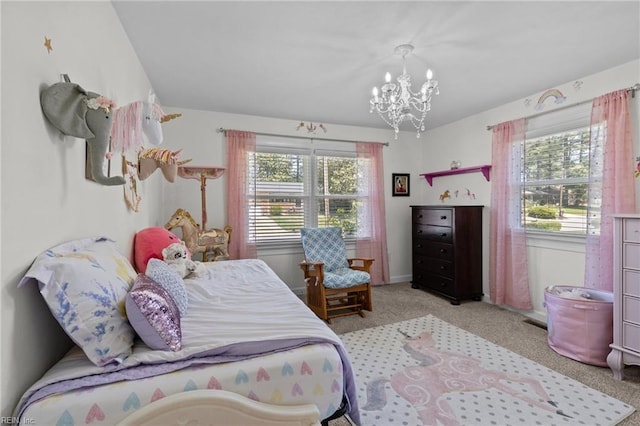 carpeted bedroom with multiple windows and a chandelier