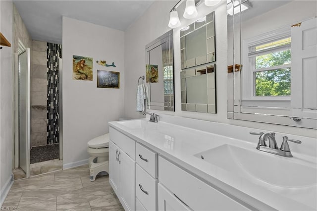 full bathroom with toilet, tiled shower, baseboards, and double vanity