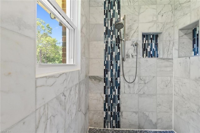 bathroom with a tile shower