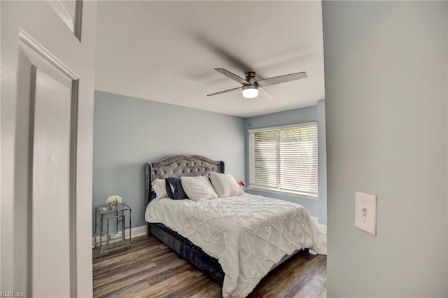 bedroom with wood finished floors, baseboards, and ceiling fan