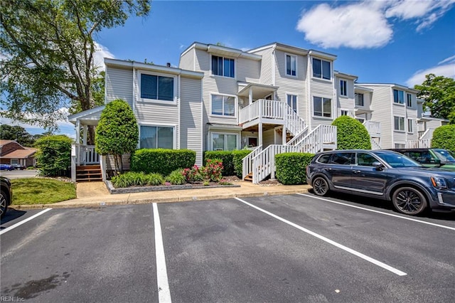 uncovered parking lot featuring stairway and a residential view