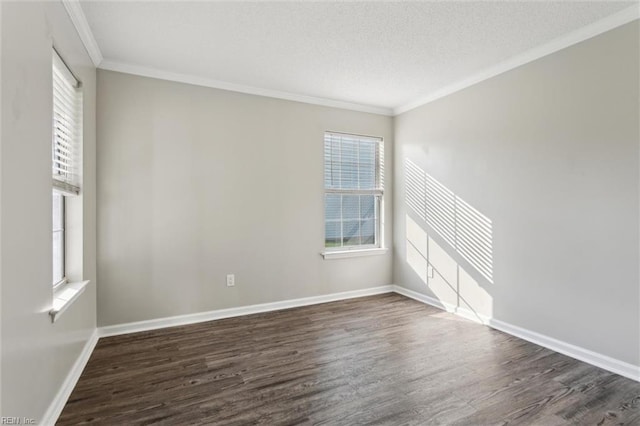 empty room featuring dark wood-style floors, crown molding, baseboards, and a textured ceiling