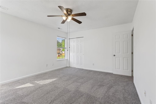 unfurnished room with ceiling fan, carpet, and baseboards