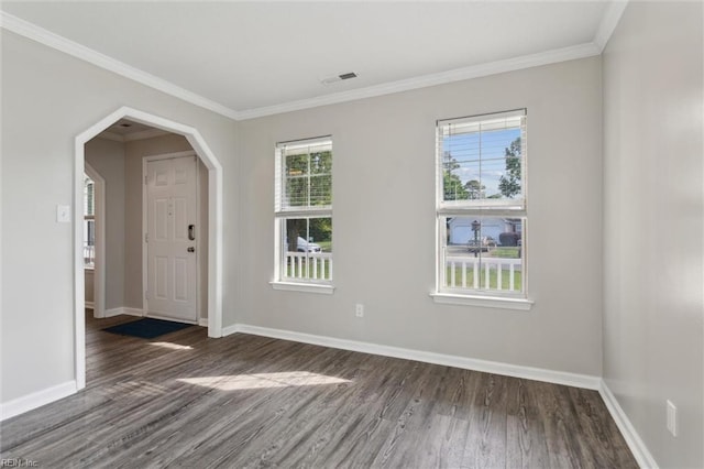 entryway with wood finished floors, baseboards, and ornamental molding