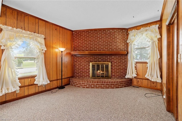 2916 Taylor Rd, Chesapeake, VA 23321 - unfurnished living room featuring healthy amount of natural light, carpet flooring, wooden walls, a brick fireplace, and baseboards