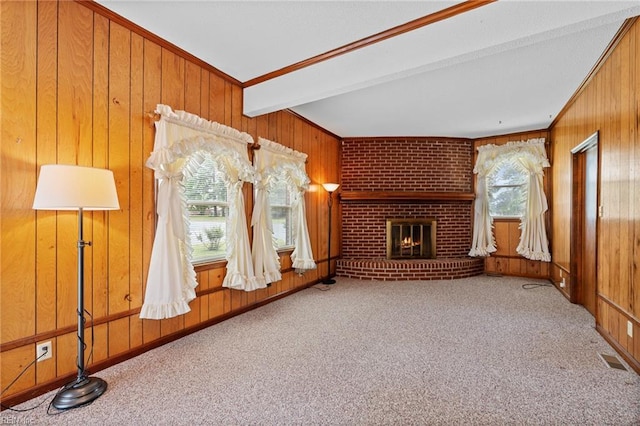 2916 Taylor Rd, Chesapeake, VA 23321 - unfurnished living room featuring a brick fireplace, wood walls, carpet flooring, beam ceiling, and ornamental molding
