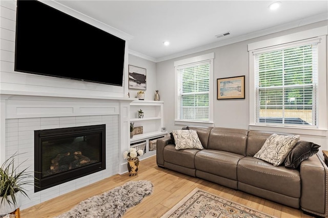2349 Treesong Trl, Virginia Beach, VA 23456 - living area with wood finished floors, crown molding, a glass covered fireplace, and recessed lighting