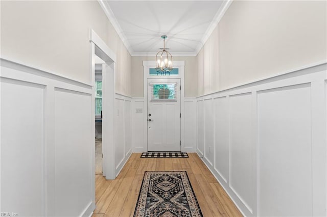 2349 Treesong Trl, Virginia Beach, VA 23456 - entryway featuring a chandelier, a decorative wall, crown molding, light wood finished floors, and wainscoting
