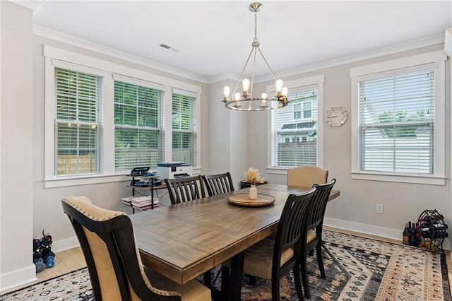 2349 Treesong Trl, Virginia Beach, VA 23456 - dining room with healthy amount of natural light, baseboards, a chandelier, light wood-type flooring, and crown molding