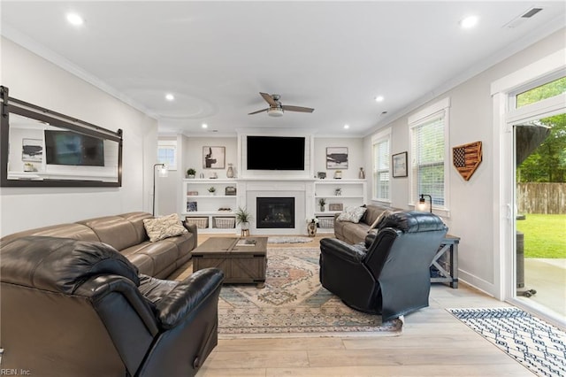 2349 Treesong Trl, Virginia Beach, VA 23456 - living room featuring light wood-style floors, ornamental molding, a ceiling fan, recessed lighting, and a glass covered fireplace