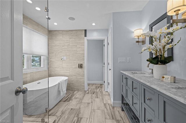 2509 Lone Pine Pt, Virginia Beach, VA 23451 - full bathroom featuring a freestanding tub, vanity, recessed lighting, tile walls, and baseboards
