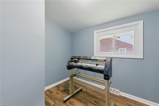 living area with wood finished floors and baseboards
