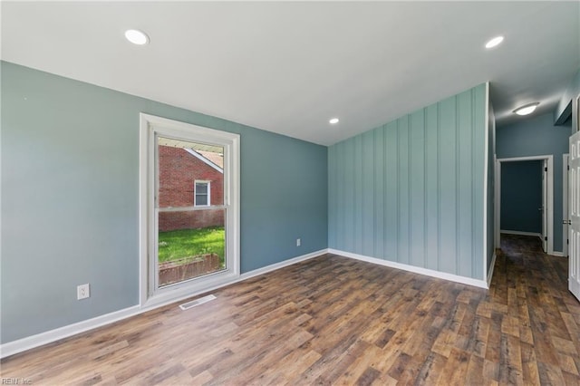 unfurnished room with wood finished floors, baseboards, and recessed lighting