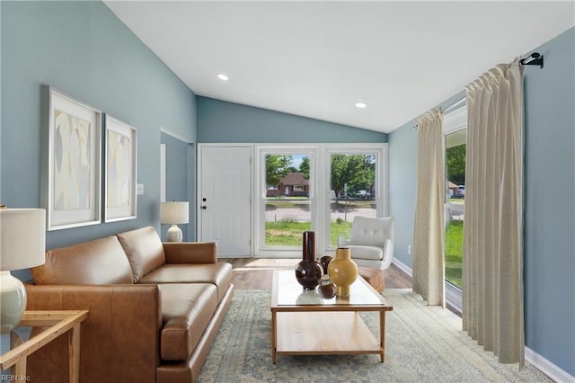 living area with vaulted ceiling, recessed lighting, wood finished floors, and baseboards