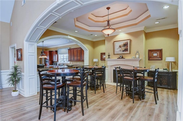 1429 Blairwood Ln Unit 117, Chesapeake, VA 23320 - dining room with crown molding, a raised ceiling, light wood-style floors, and arched walkways
