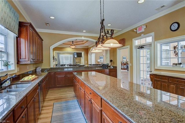 1429 Blairwood Ln Unit 117, Chesapeake, VA 23320 - kitchen featuring a sink, stainless steel dishwasher, arched walkways, light wood-style flooring, and light stone counters