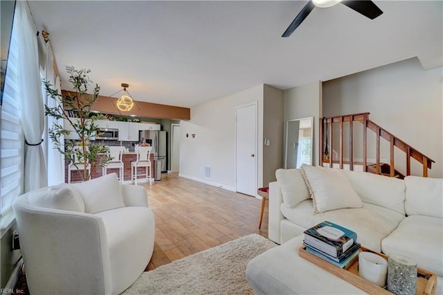 100 Castilian Dr, Virginia Beach, VA 23462 - living area with ceiling fan, light wood-style floors, stairway, and baseboards