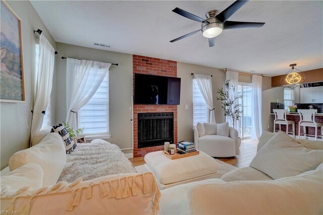 100 Castilian Dr, Virginia Beach, VA 23462 - living area featuring a ceiling fan, light wood-style flooring, and a brick fireplace