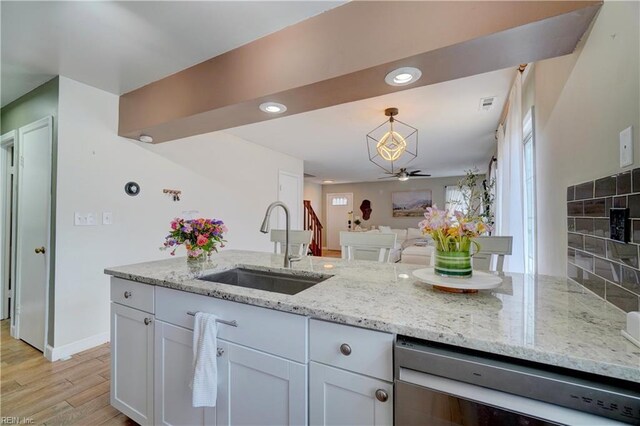 100 Castilian Dr, Virginia Beach, VA 23462 - kitchen with stainless steel dishwasher, a sink, a ceiling fan, light stone counters, and hanging light fixtures
