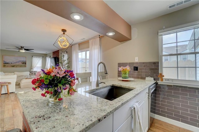 100 Castilian Dr, Virginia Beach, VA 23462 - kitchen featuring a sink, white cabinetry, light wood finished floors, light stone countertops, and open floor plan