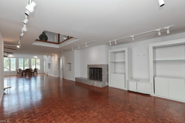6025 River Rd, Norfolk, VA 23505 - unfurnished living room featuring track lighting, a high end fireplace, and built in features