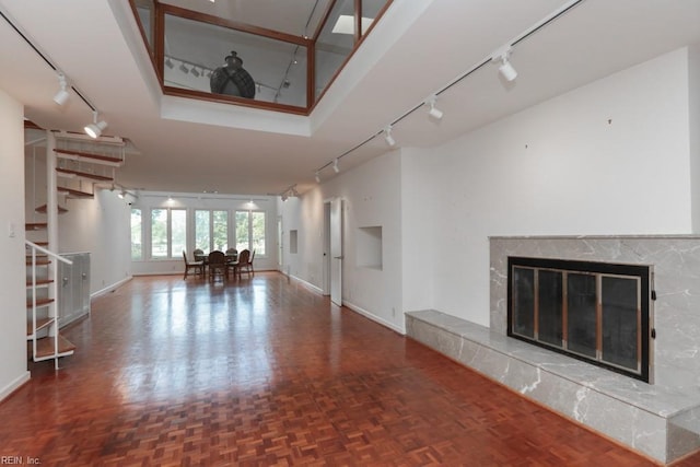 6025 River Rd, Norfolk, VA 23505 - unfurnished living room featuring rail lighting and baseboards