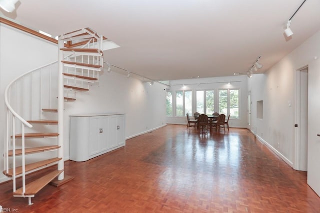 6025 River Rd, Norfolk, VA 23505 - living room featuring track lighting, stairs, and baseboards