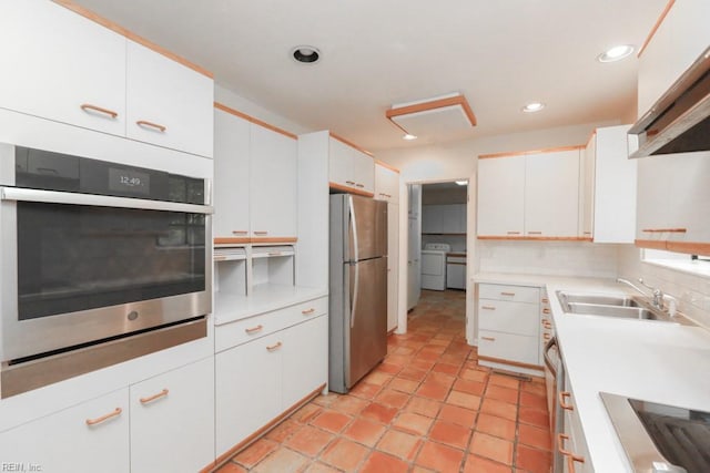 6025 River Rd, Norfolk, VA 23505 - kitchen featuring stainless steel appliances, washing machine and dryer, a sink, white cabinets, and recessed lighting