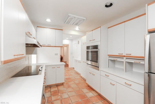6025 River Rd, Norfolk, VA 23505 - kitchen featuring appliances with stainless steel finishes, under cabinet range hood, backsplash, white cabinets, and recessed lighting