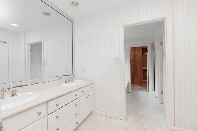 6025 River Rd, Norfolk, VA 23505 - full bath featuring tile patterned flooring, double vanity, a bathtub, and baseboards