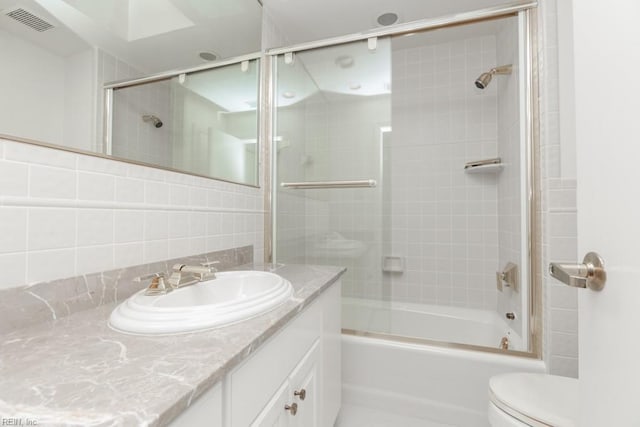 6025 River Rd, Norfolk, VA 23505 - full bath featuring toilet, vanity, combined bath / shower with glass door, and decorative backsplash