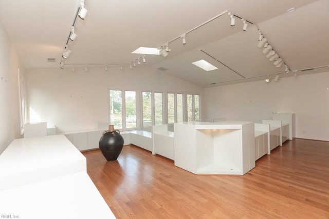 6025 River Rd, Norfolk, VA 23505 - kitchen with track lighting, light wood finished floors, lofted ceiling, and white cabinetry
