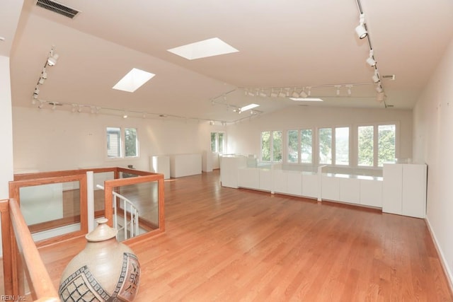 6025 River Rd, Norfolk, VA 23505 - unfurnished room with rail lighting, vaulted ceiling, a skylight, and wood finished floors