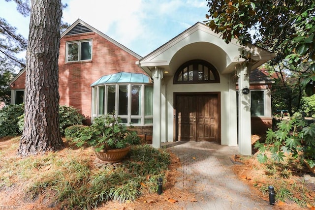 6025 River Rd, Norfolk, VA 23505 - view of exterior entry with brick siding and a standing seam roof