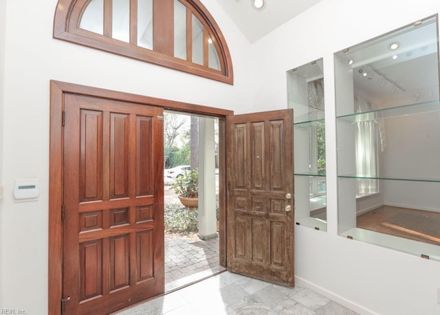 6025 River Rd, Norfolk, VA 23505 - entryway with rail lighting, baseboards, and vaulted ceiling