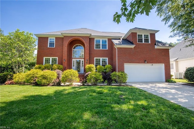 view of front of house with driveway, a front lawn, a garage, and brick siding