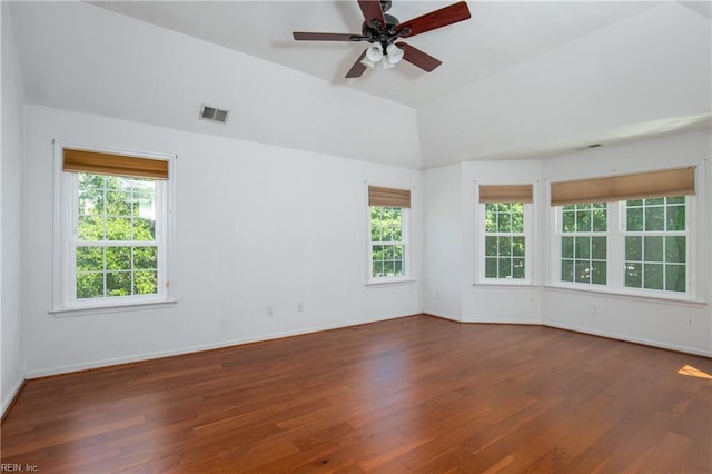 empty room featuring wood finished floors, ceiling fan, baseboards, and high vaulted ceiling