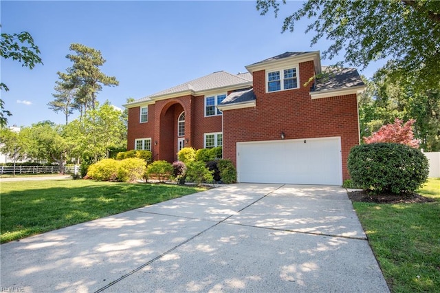 view of front of house with driveway, an attached garage, and brick siding