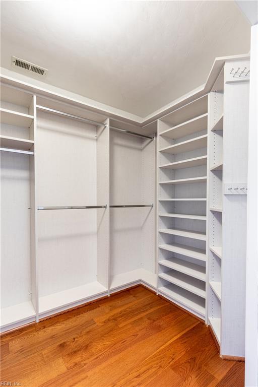 walk in closet featuring wood finished floors
