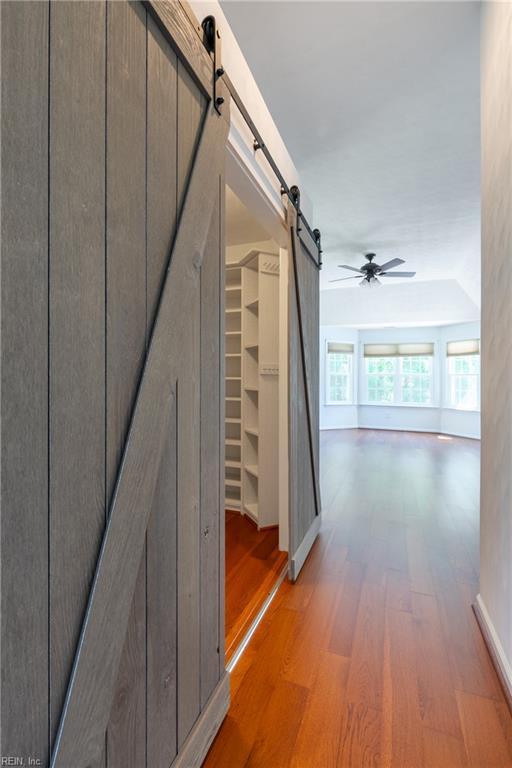 hall featuring a barn door and light wood finished floors