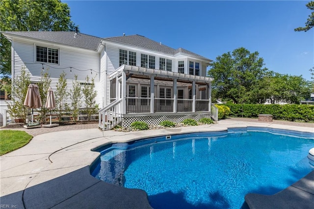 view of swimming pool with a sunroom and a patio