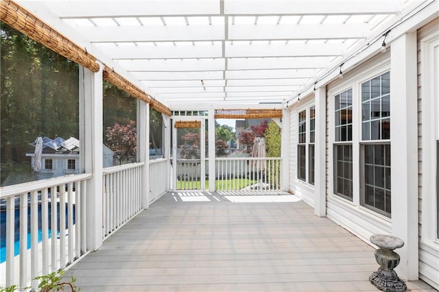 wooden terrace with an outdoor pool